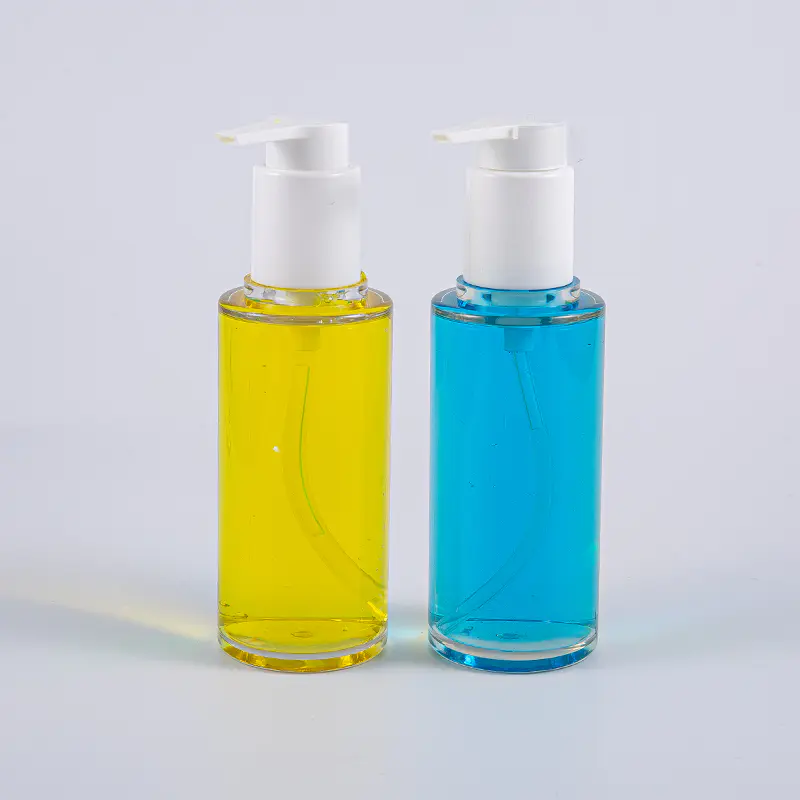 Kirkas PETG 100 ml:n pyöreä voidepullo valkoisella muovipumpulla